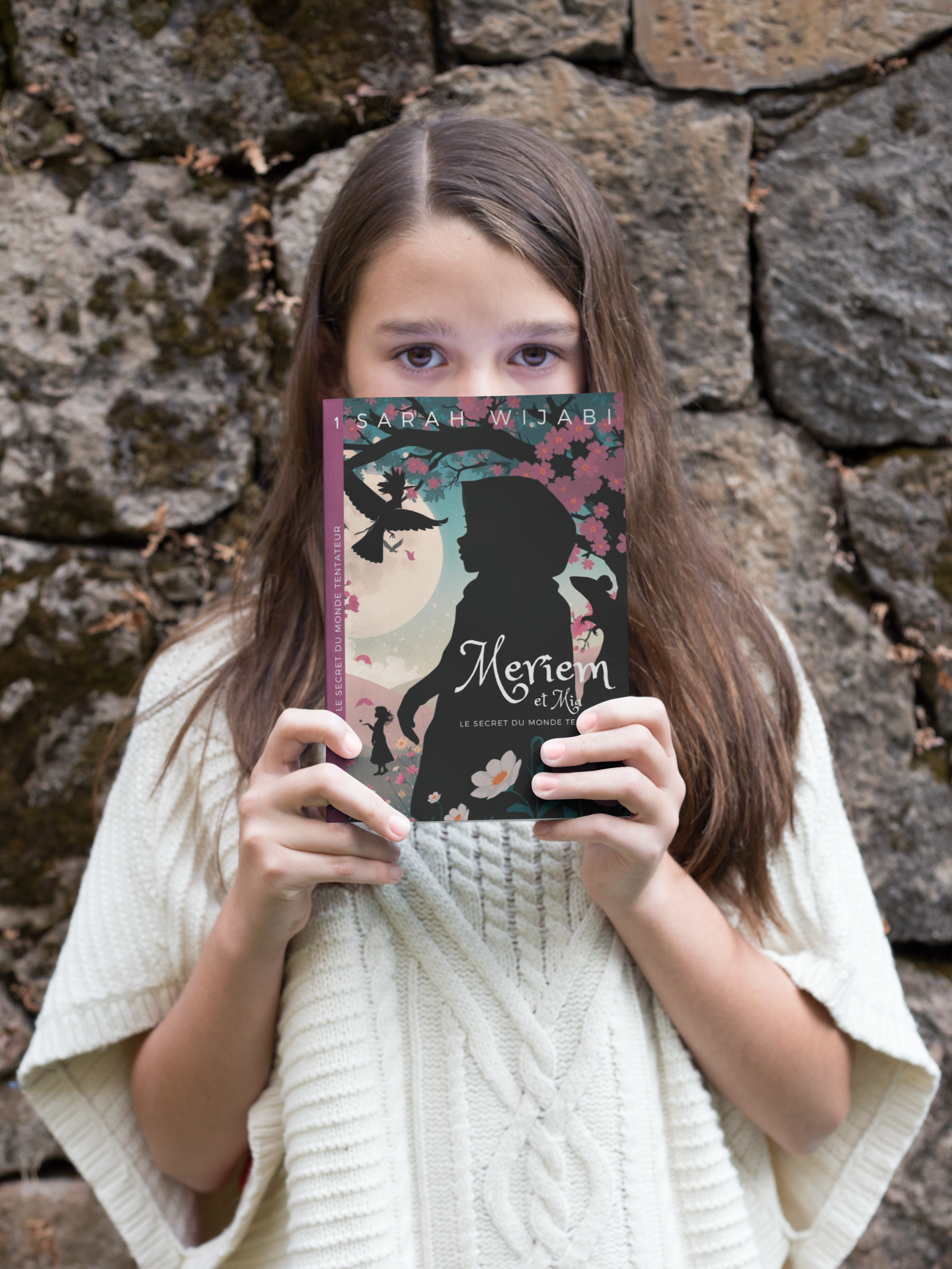 little-girl-holding-a-book-mockup-against-her-face-outdoors-a19086.png